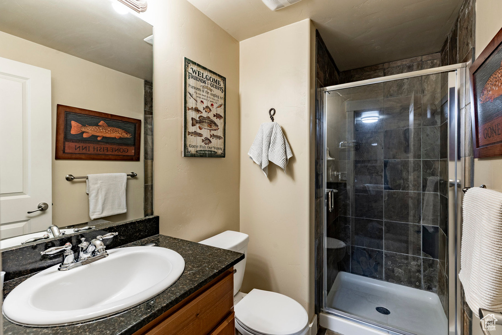 Bathroom featuring vanity and a stall shower