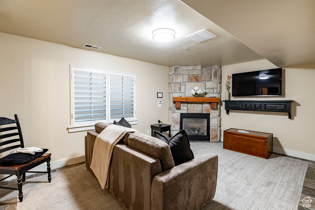 Living room with a fireplace and wood finished floors