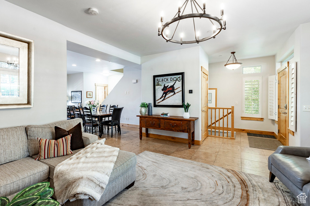 Living area with a chandelier, light tile patterned floors, and recessed lighting