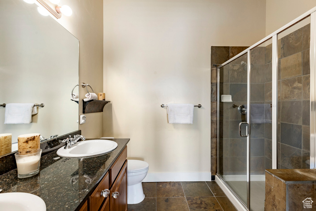 Bathroom featuring double vanity and a shower stall