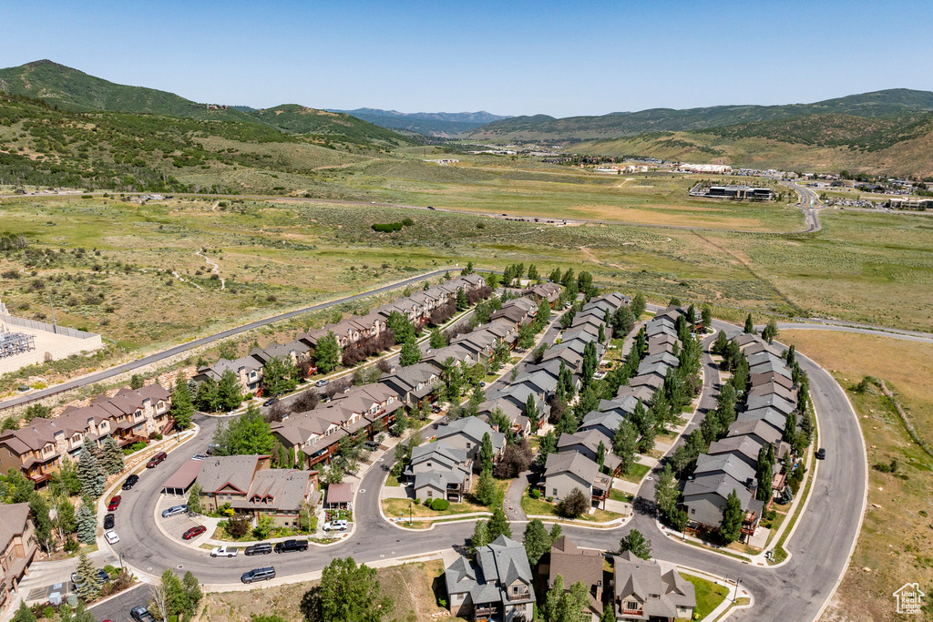 Aerial view of property's location featuring nearby suburban area and a mountain backdrop