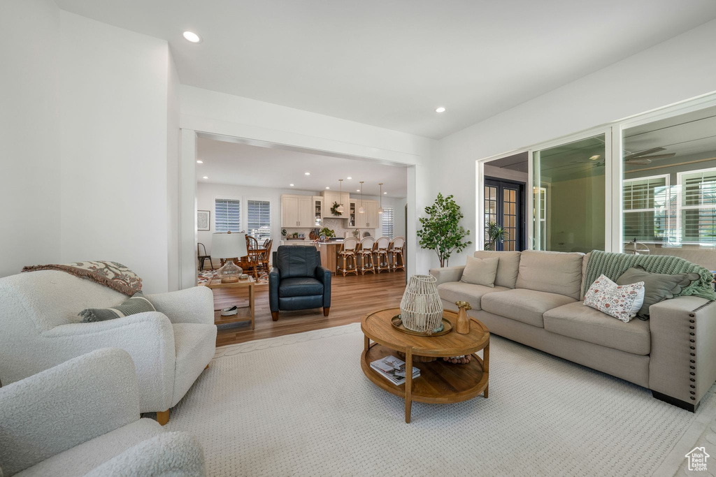 Living area featuring light wood-style floors and recessed lighting