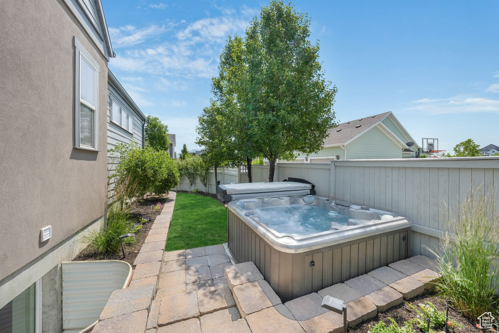 Fenced backyard with a hot tub