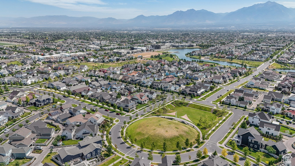 Aerial view of property's location featuring a water and mountain view and nearby suburban area