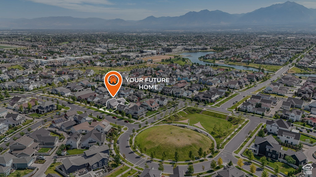 Aerial overview of property's location with a water and mountain view and nearby suburban area