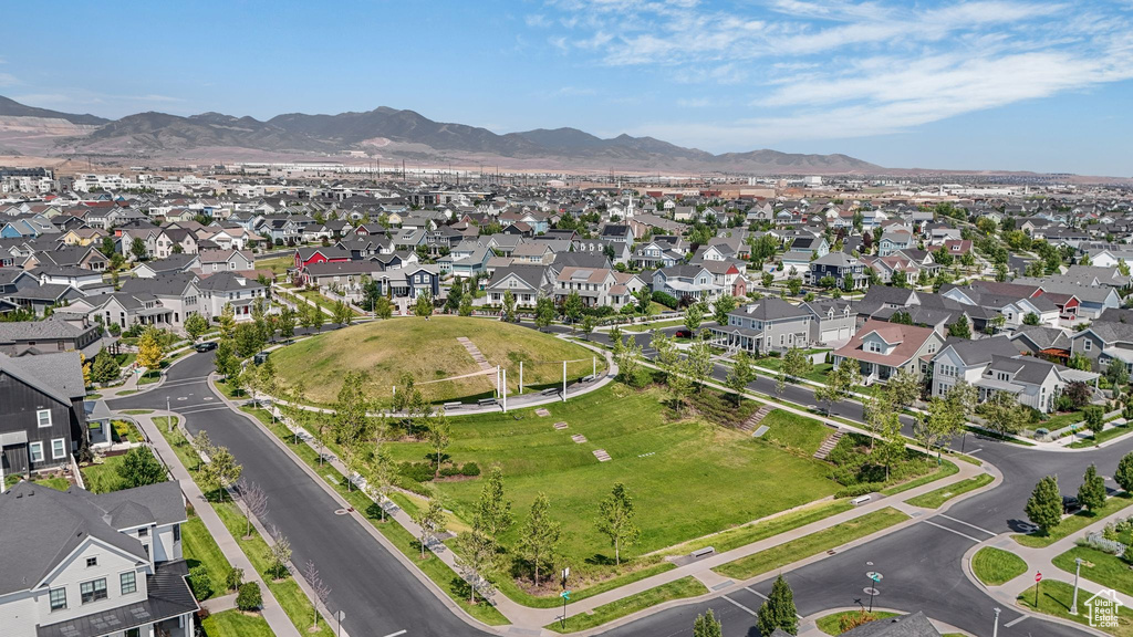Aerial view of property's location featuring a mountain backdrop and nearby suburban area