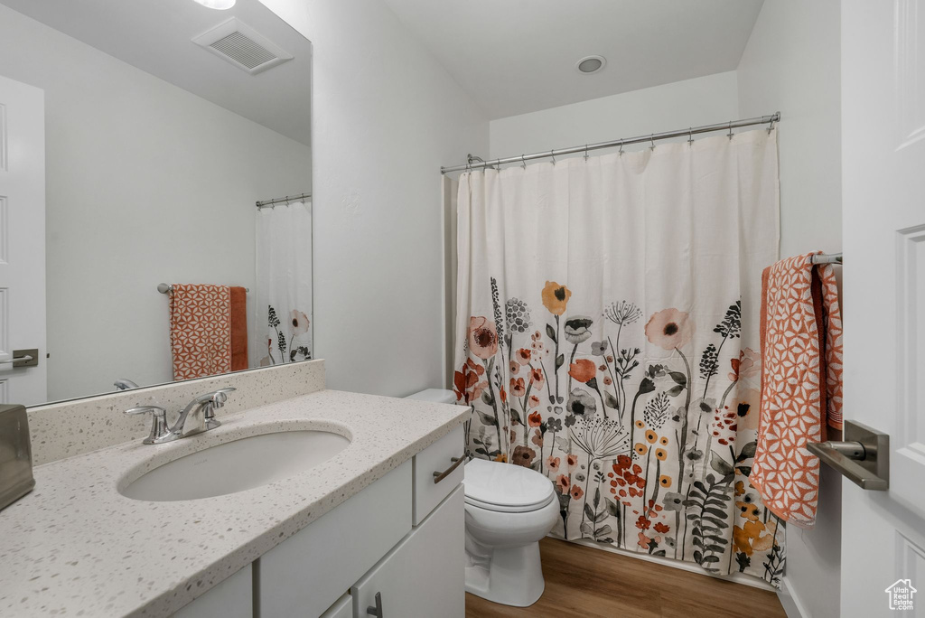 Full bathroom with wood finished floors and vanity