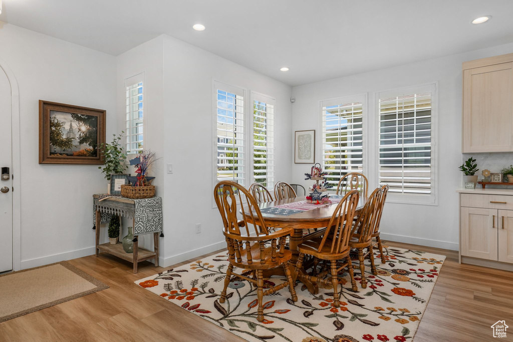 Dining area with light wood-type flooring and recessed lighting