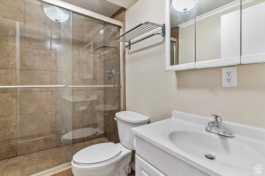 Bathroom featuring a shower stall and vanity