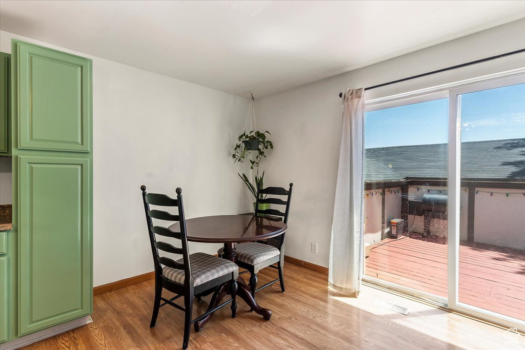 Dining area with light wood-style flooring and baseboards