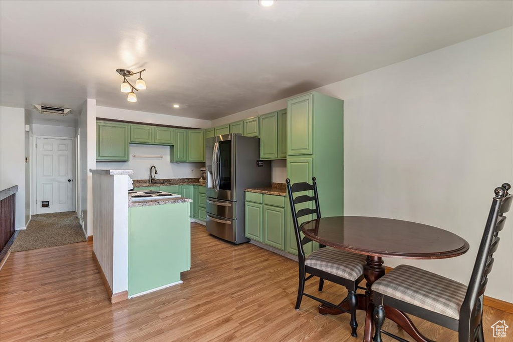 Kitchen with smart refrigerator, green cabinetry, light wood finished floors, and recessed lighting