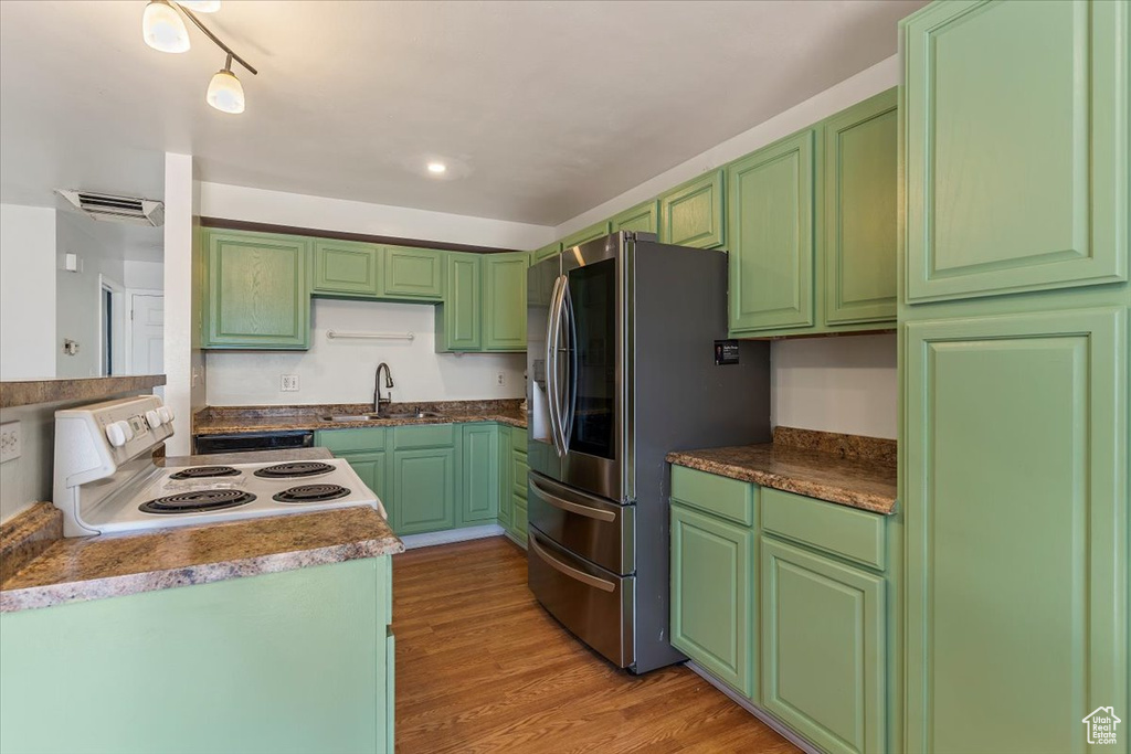 Kitchen with smart refrigerator, white electric range, and light wood-type flooring