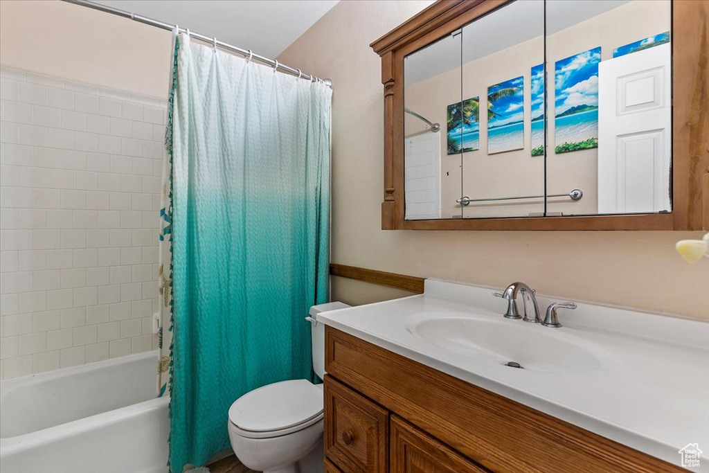 Full bath featuring vanity and shower / tub combo with curtain
