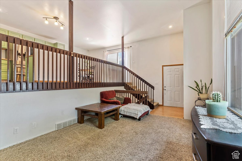 Sitting room featuring carpet floors and stairs