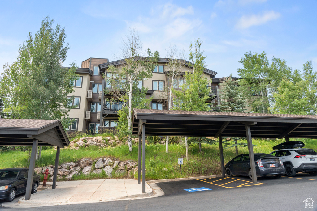 View of property featuring covered parking