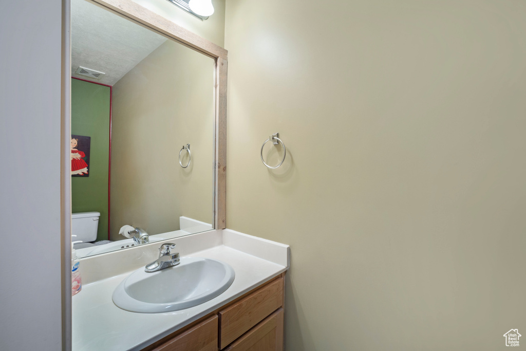 Bathroom featuring vanity and toilet