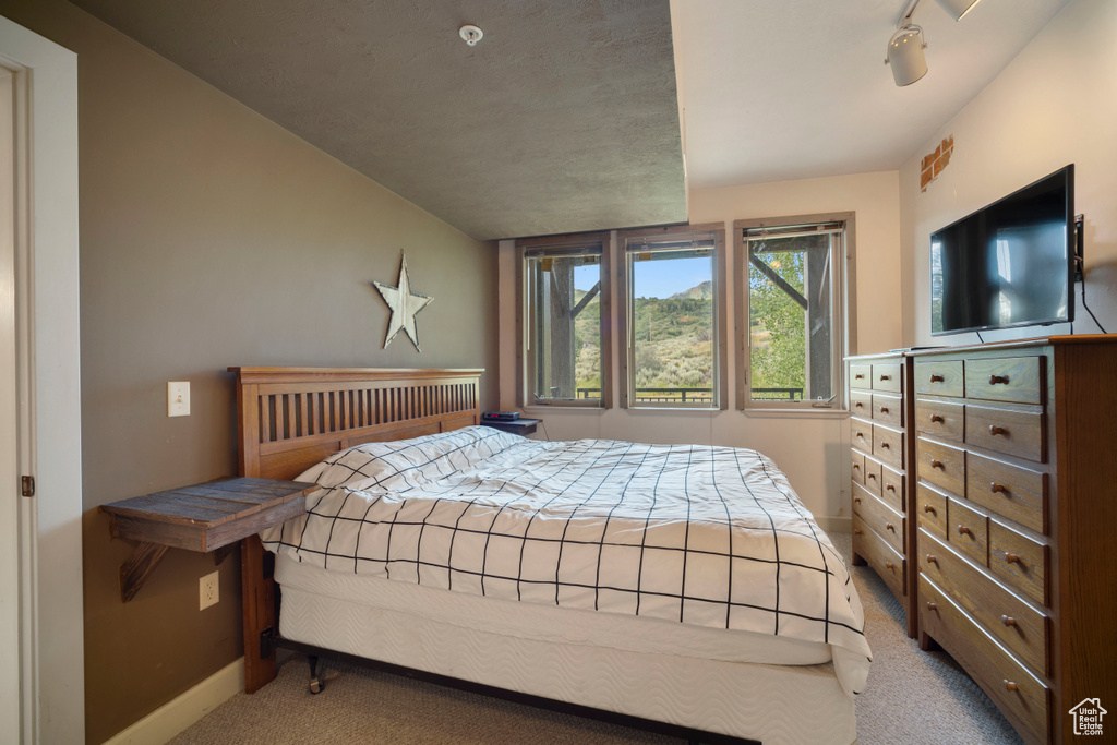 Carpeted bedroom with baseboards