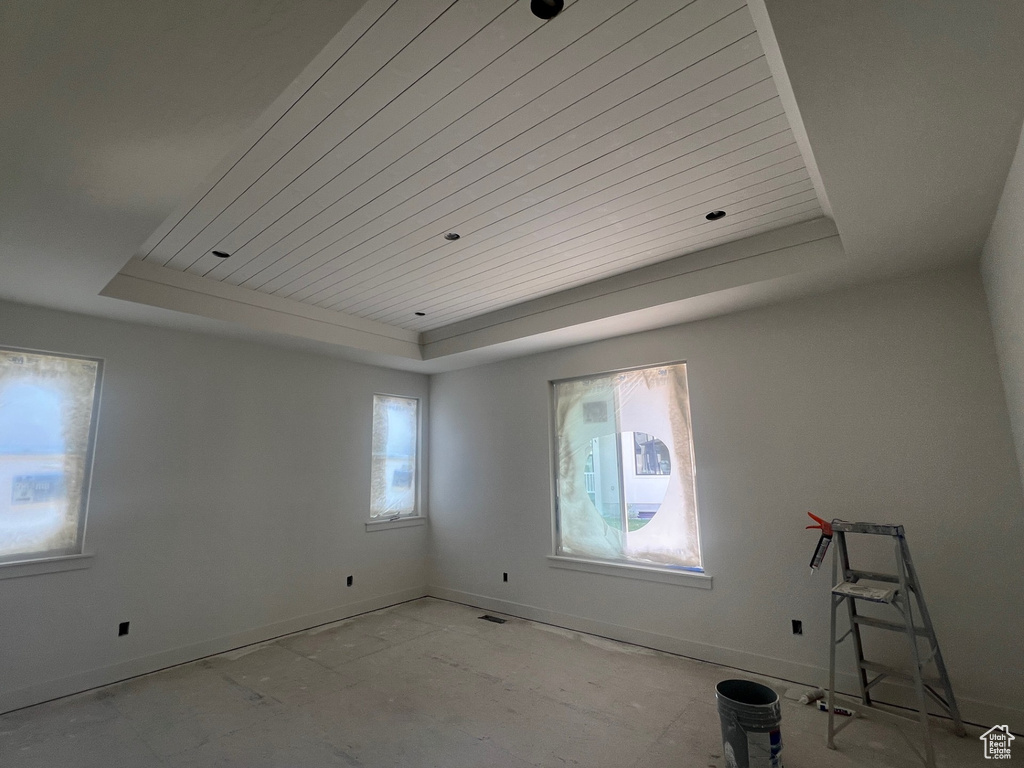 Spare room with a tray ceiling and wooden ceiling