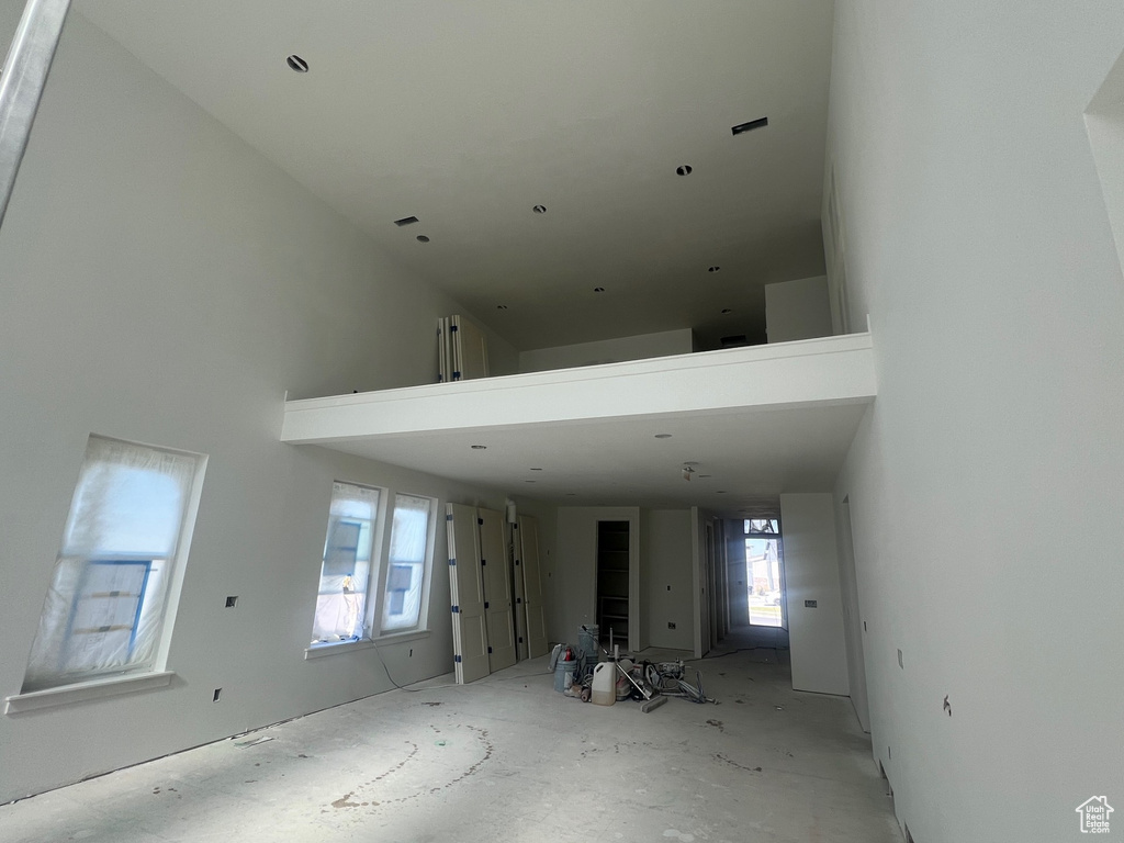 Unfurnished living room with a high ceiling