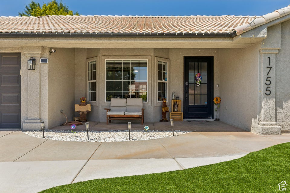Entrance to property featuring stucco siding and a tile roof