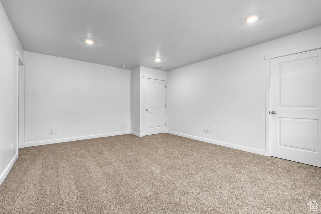 Carpeted spare room with recessed lighting