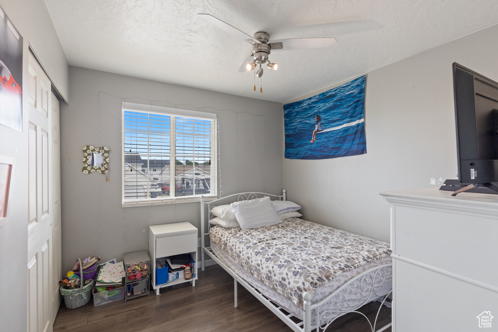 Bedroom with wood finished floors, a closet, and ceiling fan