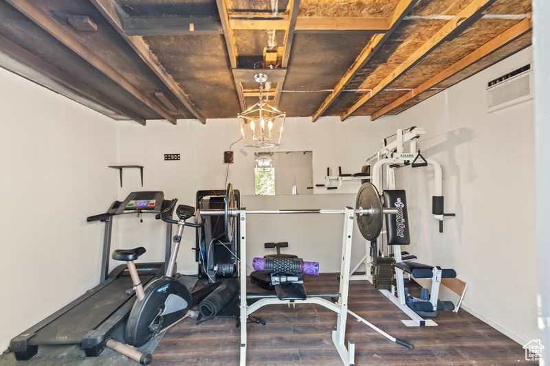 Workout room with wood finished floors and baseboards