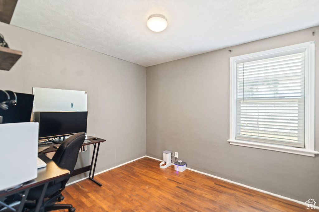 Office space with dark wood-style floors and baseboards