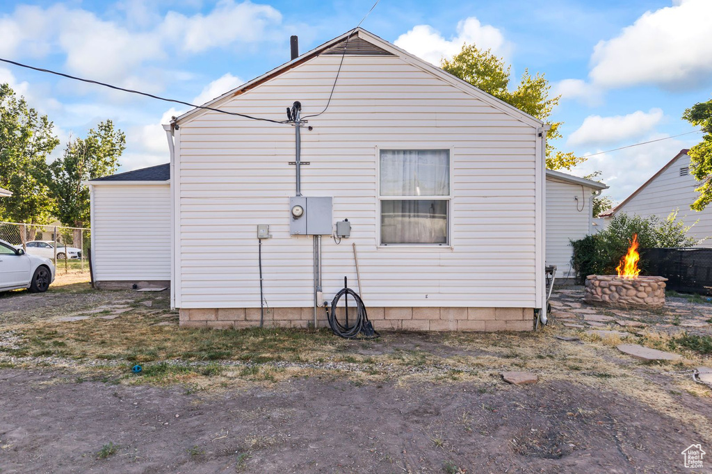 View of side of property featuring a fire pit