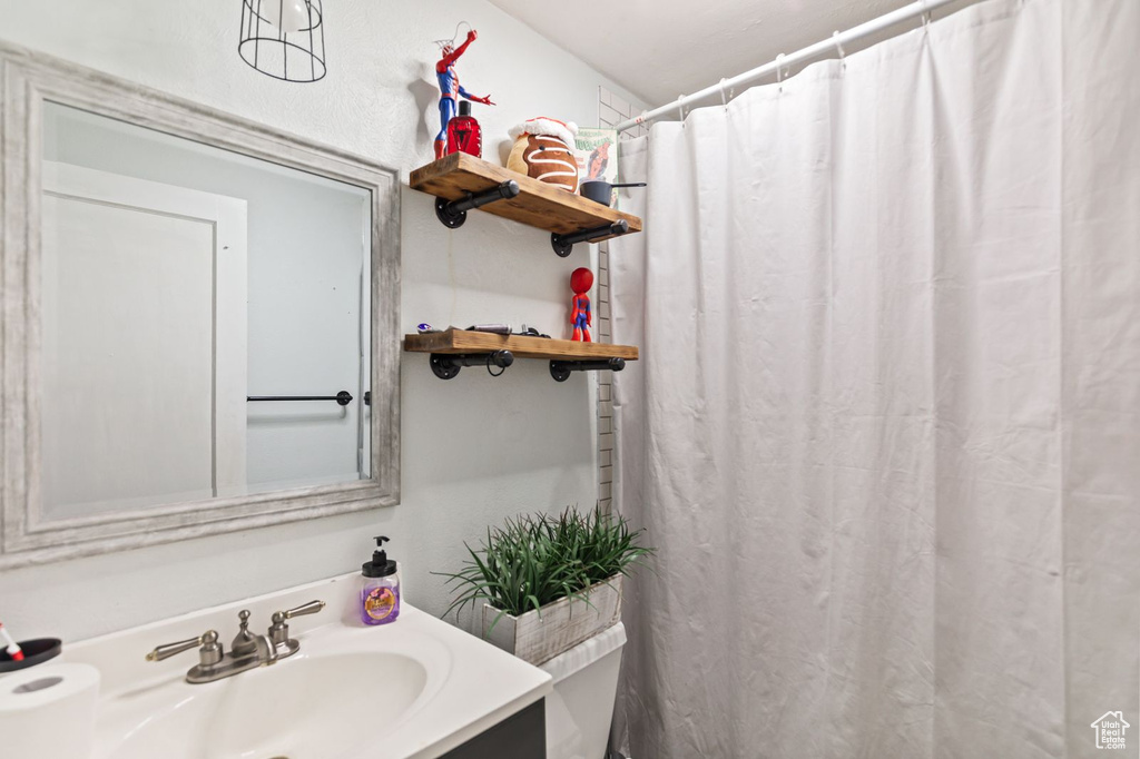 Bathroom featuring vanity and curtained shower