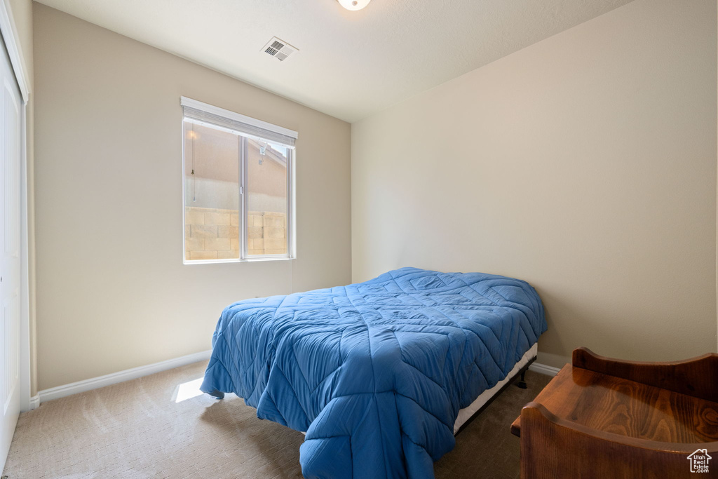 Bedroom with carpet and baseboards