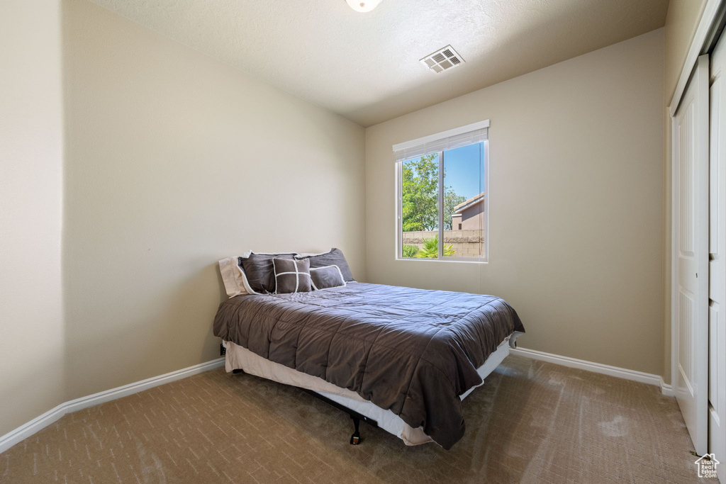 Bedroom with carpet flooring and a closet