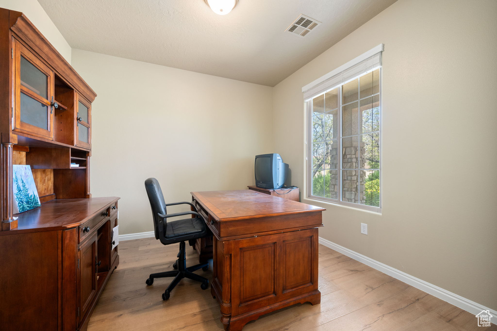 Office space with baseboards and light wood finished floors