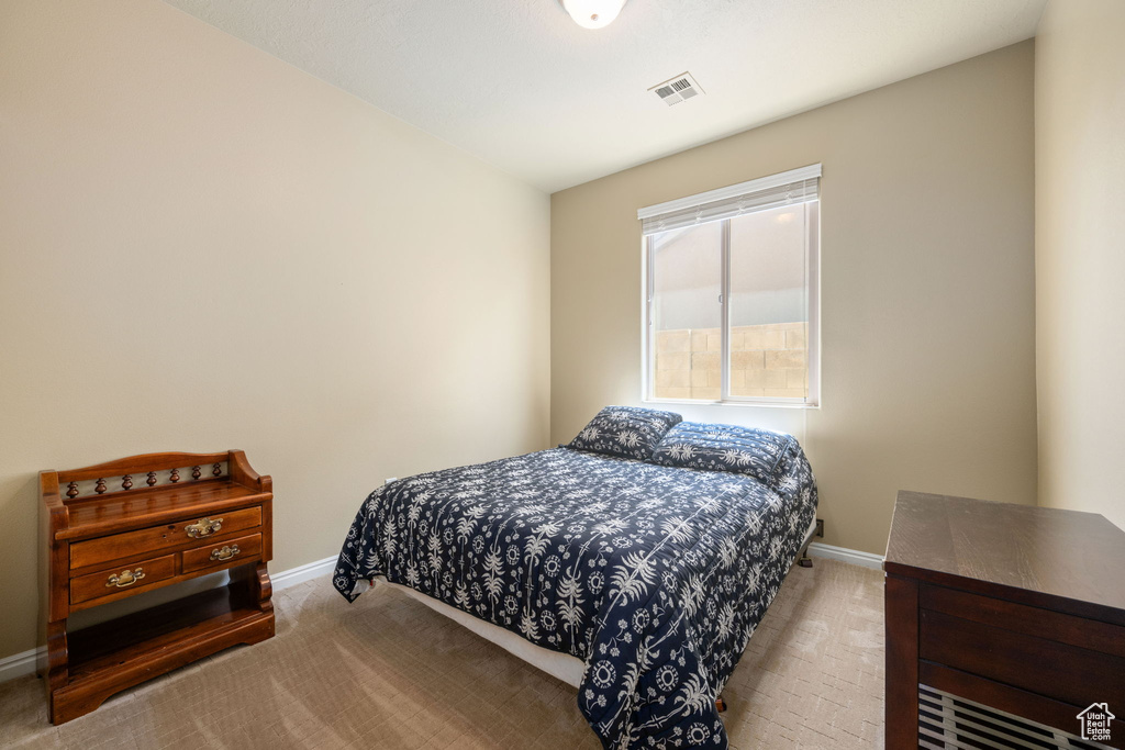 Bedroom featuring carpet flooring and baseboards