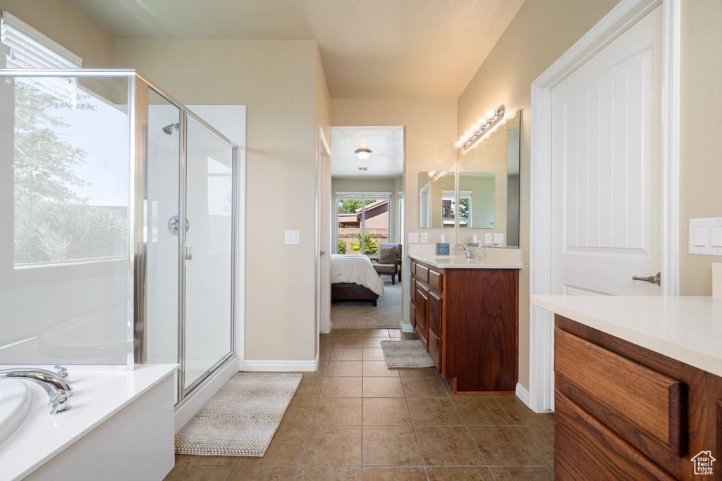Ensuite bathroom with a stall shower, vanity, a bath, and tile patterned floors