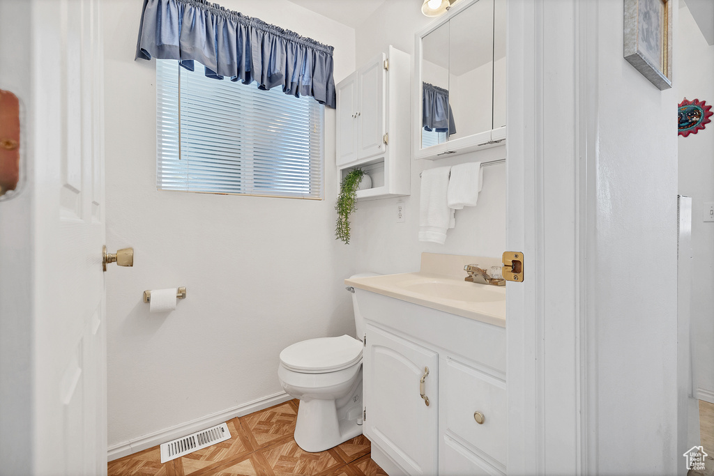 Half bathroom featuring toilet and vanity