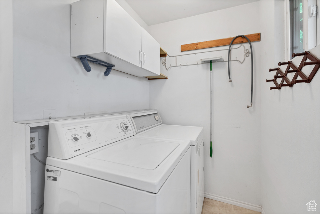 Laundry room featuring cabinet space and washing machine and clothes dryer