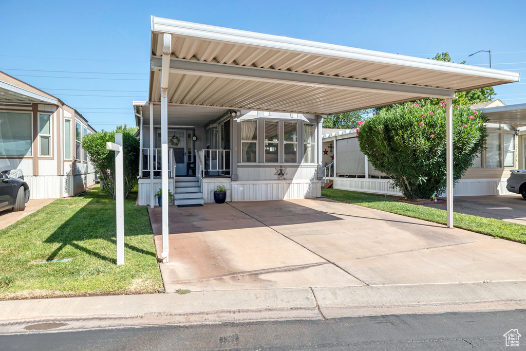 View of car parking featuring an attached carport and entry steps
