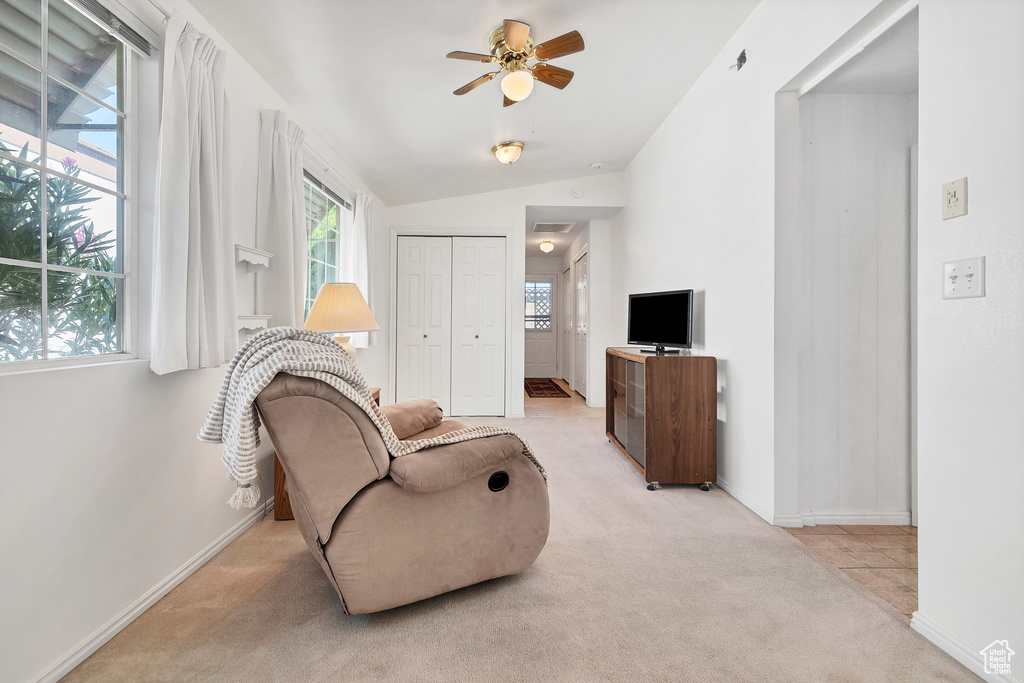 Sitting room featuring carpet flooring, a ceiling fan, and vaulted ceiling