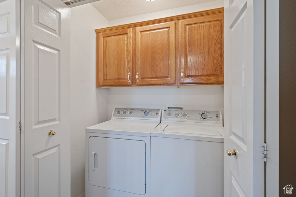 Washroom with washing machine and dryer and cabinet space