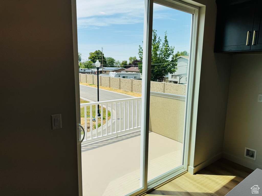 Doorway featuring wood finished floors and baseboards