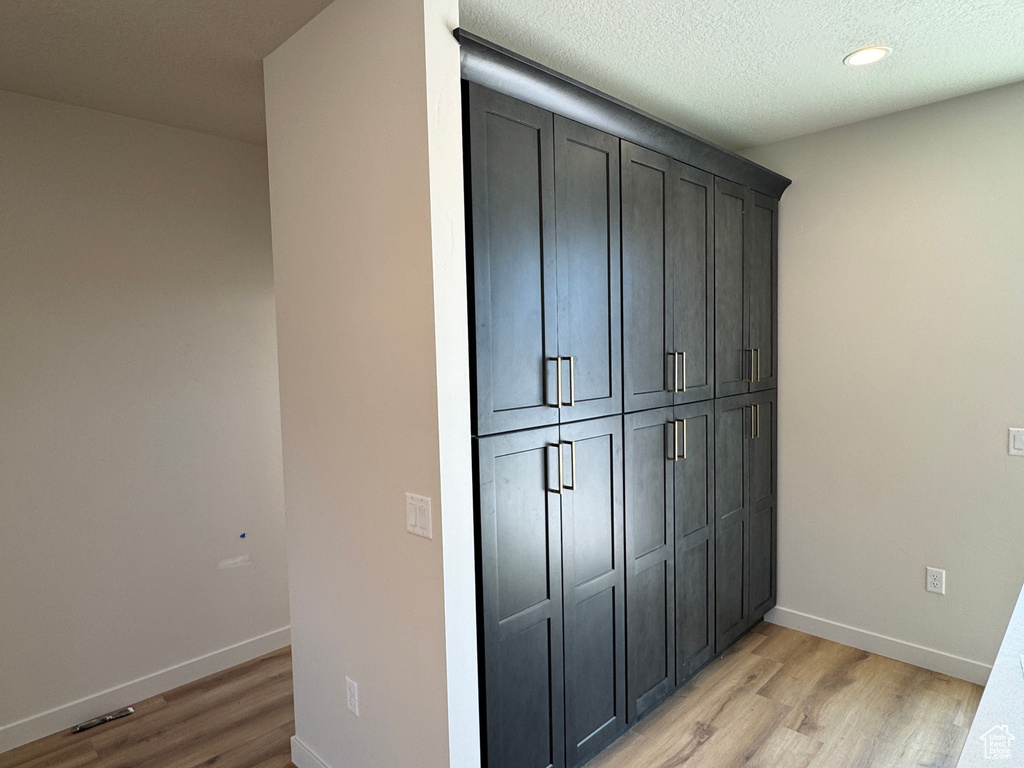 Detailed view of wood finished floors and recessed lighting