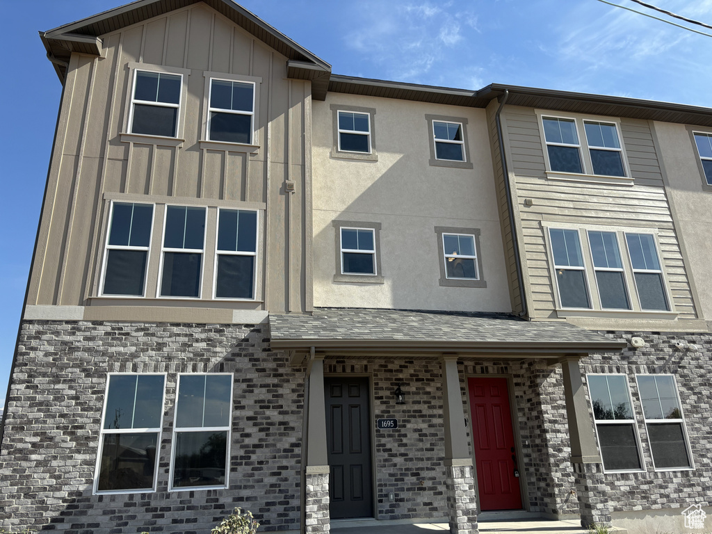 View of front of home featuring board and batten siding and brick siding