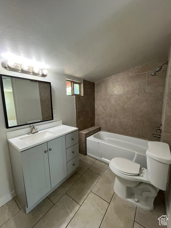 Full bathroom featuring vanity, tile patterned flooring, and a textured ceiling