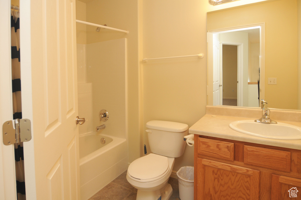 Bathroom featuring vanity, bathtub / shower combination, and tile patterned floors