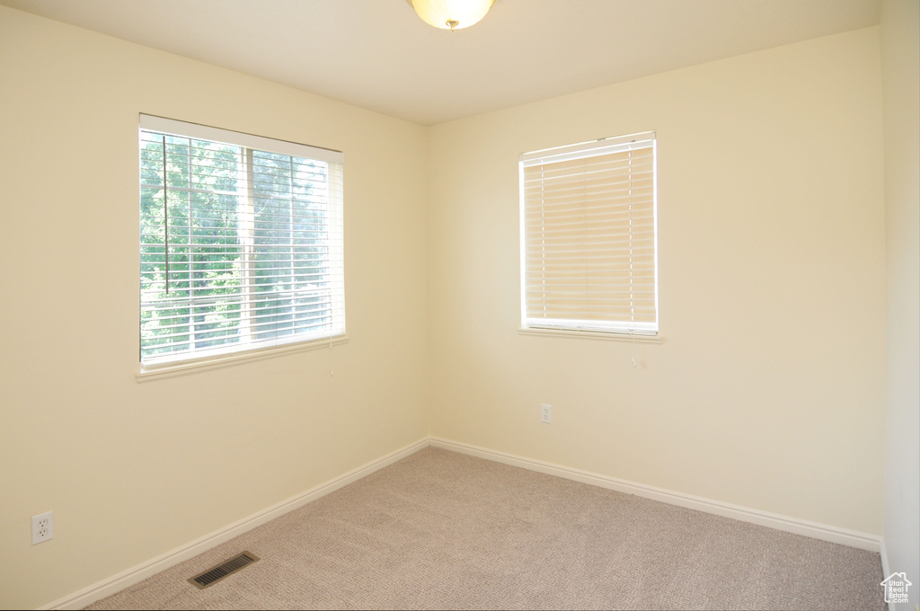 Carpeted spare room with baseboards