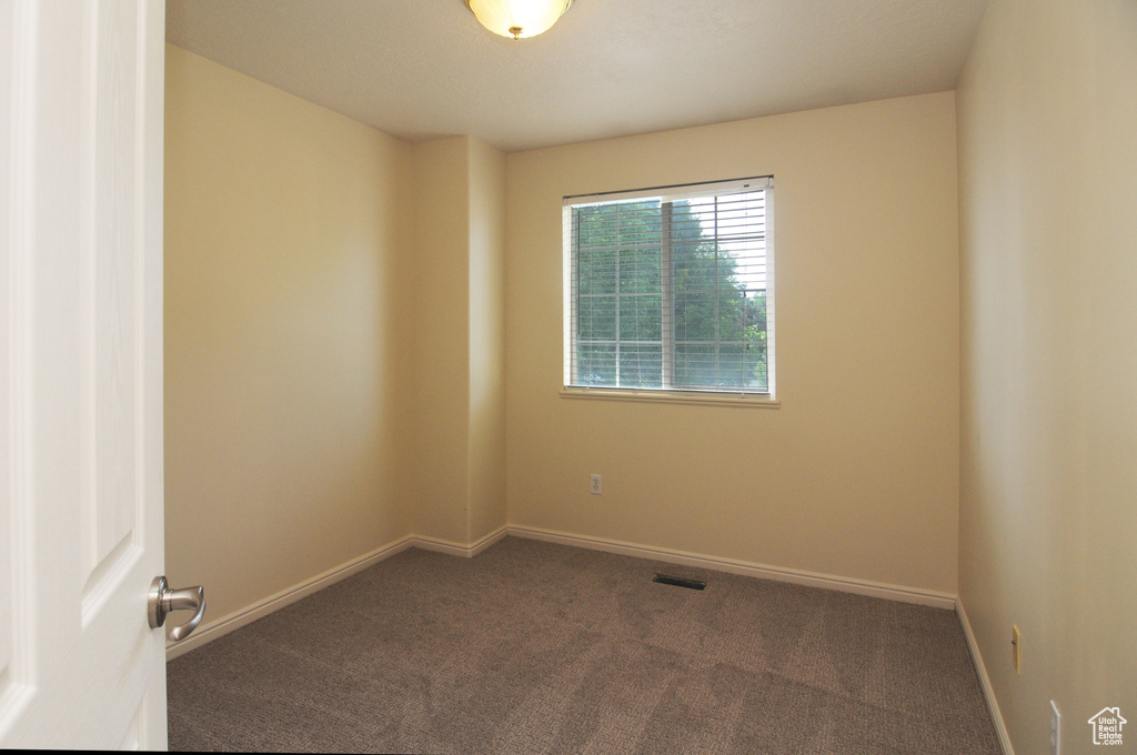 Unfurnished room featuring carpet flooring and baseboards