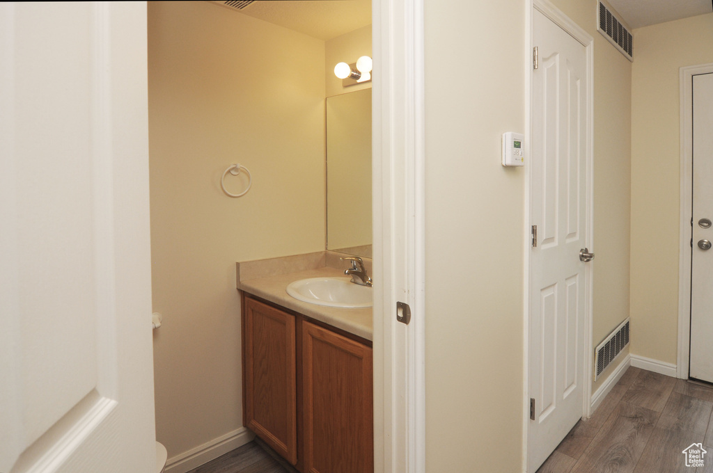 Bathroom featuring vanity and wood finished floors