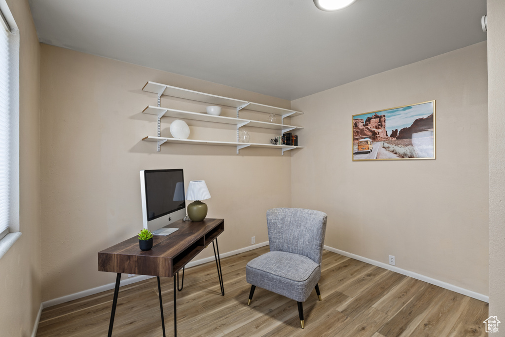Living area with wood finished floors and a desk