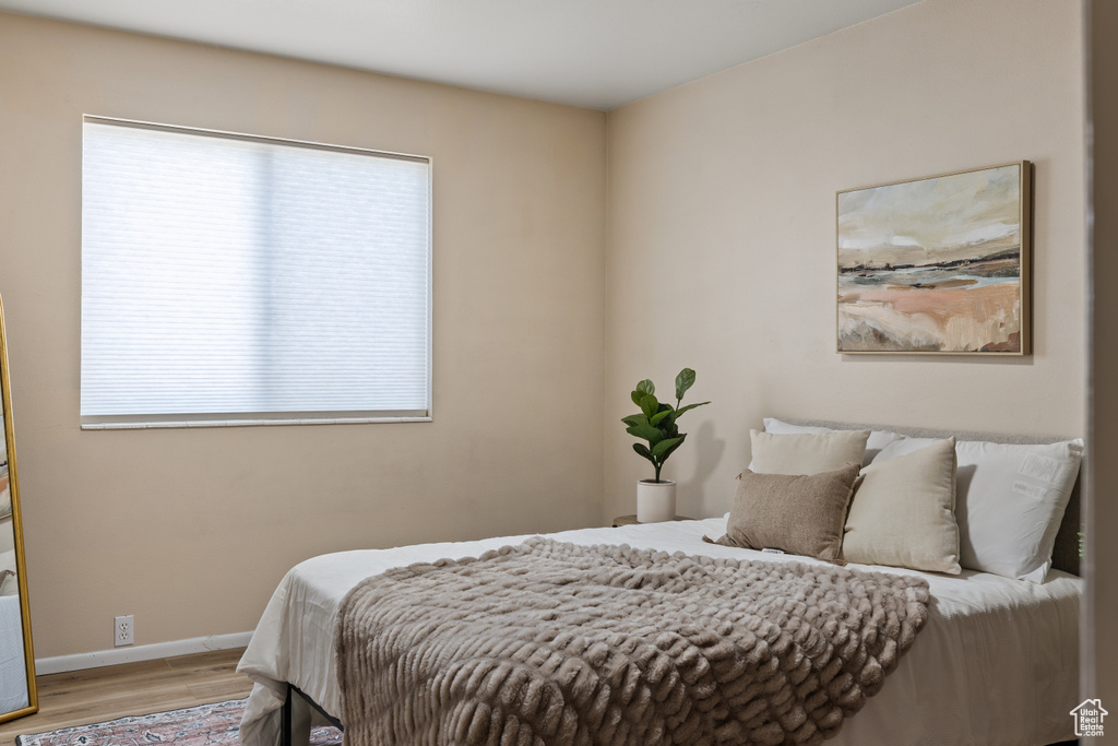 Bedroom featuring wood finished floors and baseboards